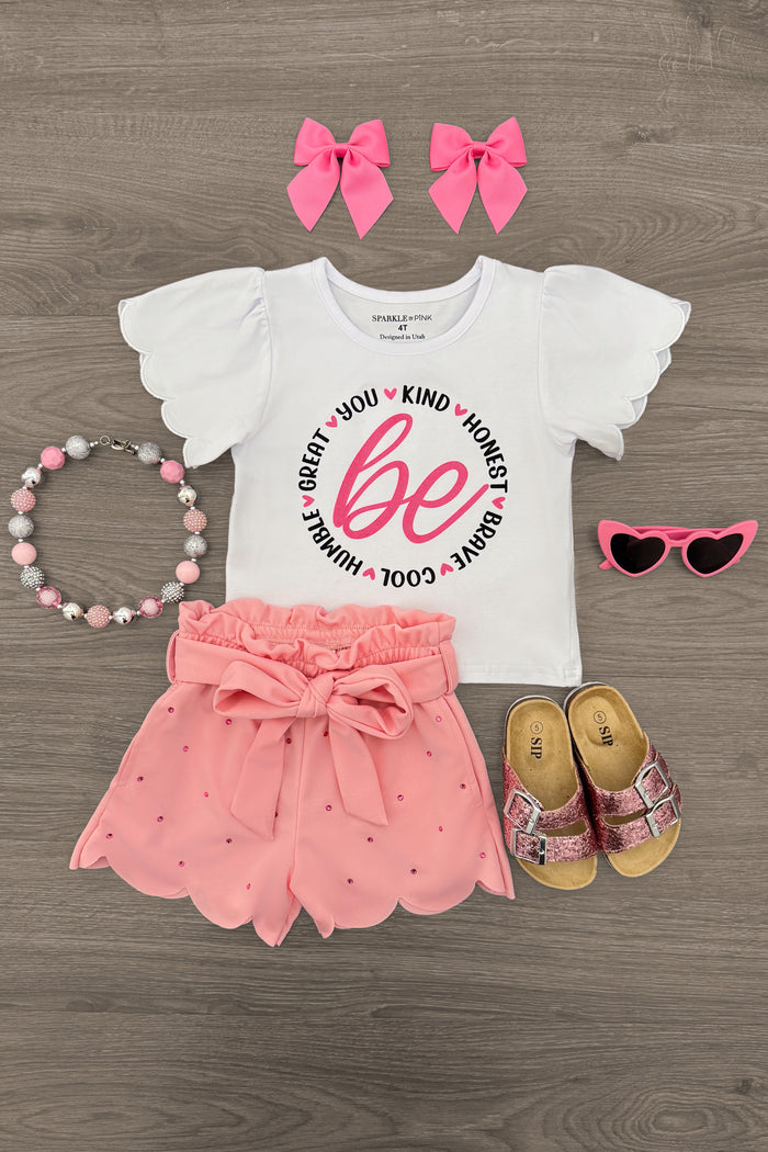 "Be You..." Pink Short Set - 6-12 Months - Girls' white puff-sleeve top with "Be You" pink script, pink eyelet ruffle shorts, matching pink bows, necklace, pink.