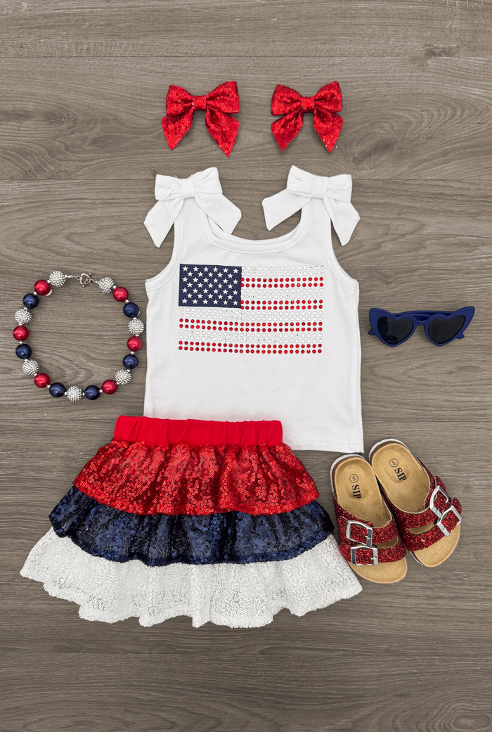 American Flag Sequin Skirt Set - 6-12 Months - Toddler American flag tank top with red, white, and blue sequin tiered skirt, matching red bows, beaded bracelet,.