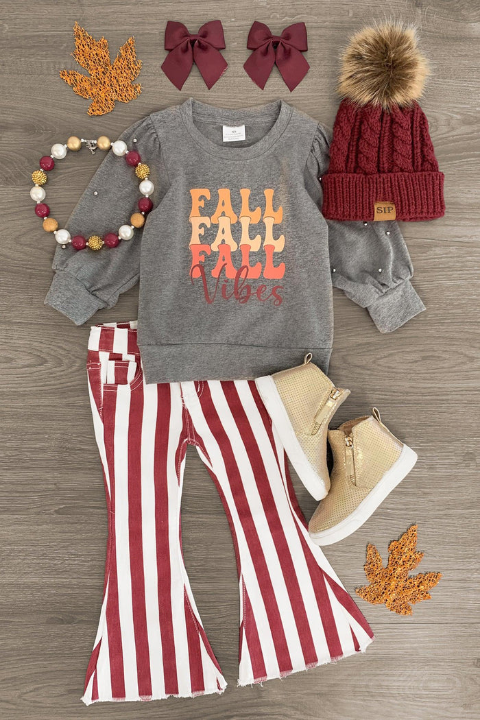 "Fall Vibes" Burgundy Striped Bell Bottom Set - 3XS-6-12 Months - Gray long-sleeve shirt with "Fall Vibes" text, red and white striped bell bottom pants, red knit hat with pompom, tan boots, .