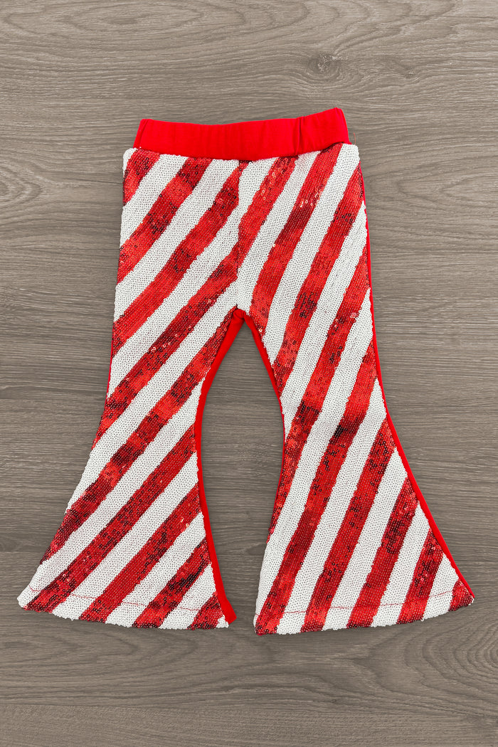 Red & White Striped Sequin Bell Bottoms - 3XS-6-12 Months - Red and white diagonal striped sequin bell bottoms with a red elastic waistband on wood floor background.