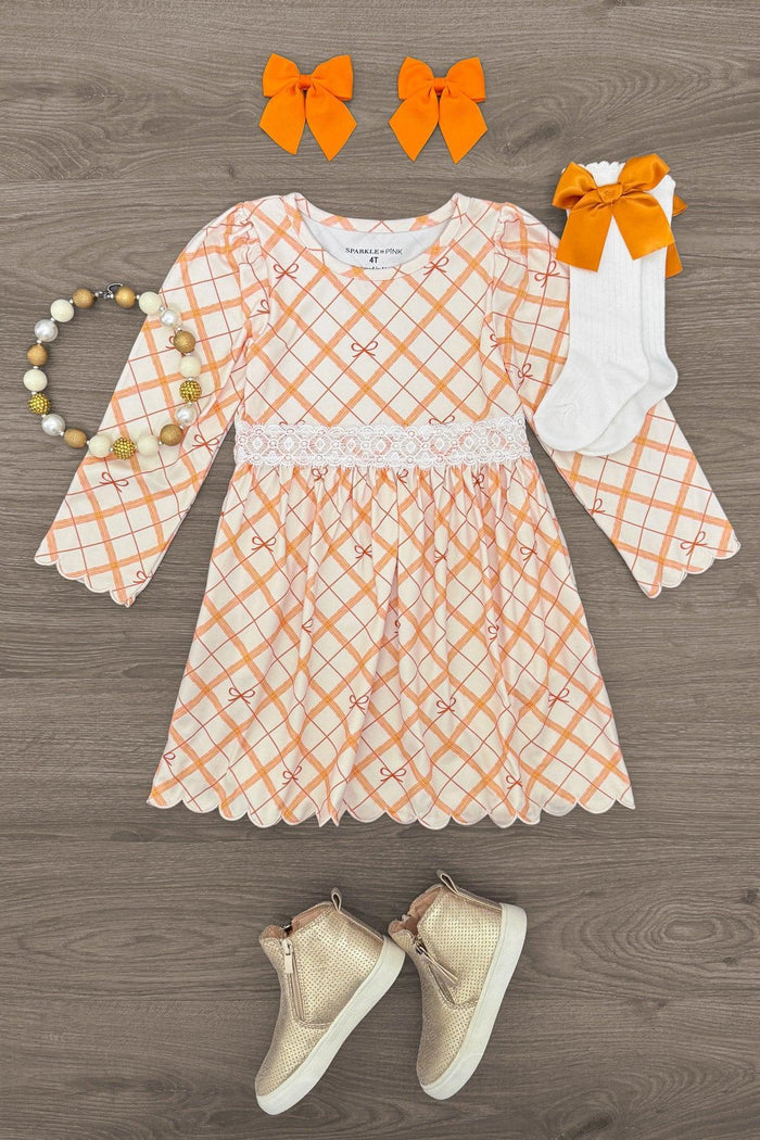 Orange Plaid Bow Dress - 6-12 Months - Orange and white plaid long-sleeve dress with a bow at the waist, paired with matching orange bow clips, white knee-high.