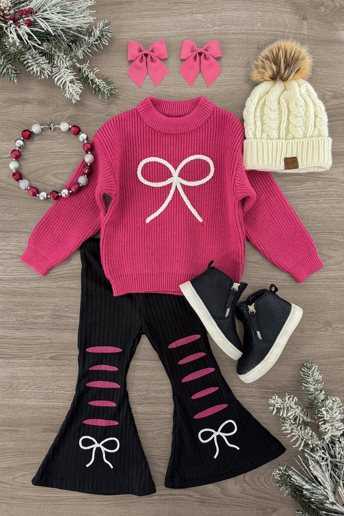 Raspberry Rose Bow Sweater Bell Bottom Set - 3XS-6-12 Months - Pink knit sweater with white bow design paired with black bell-bottom pants featuring pink slits and white bows, matching.