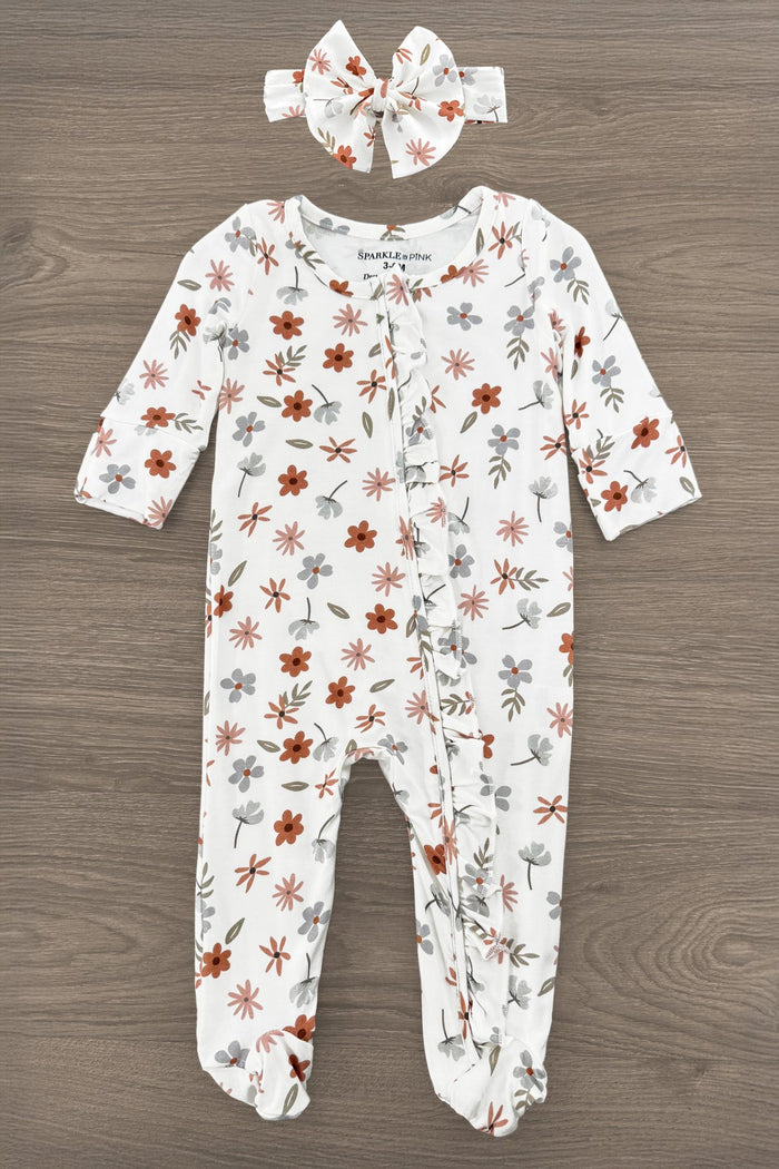 Bamboo Golden Petals Onesie - Newborn - Cream bamboo onesie with golden floral petals and matching bow headband on wood background.