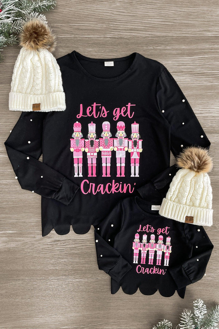 Mom & Me - "Let's Get Crackin'" Black Top - CHILD-3XS-6-12 Months - Black long-sleeve tops with pink nutcracker graphic and "Let's get Crackin'" text, scalloped edges, paired with white knit.