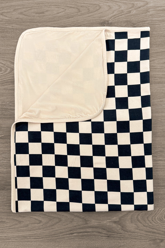Bamboo Modern Checks Double Sided Blanket - Default Title - Double-sided blanket with black and cream checkerboard pattern and solid cream reverse on wood background.