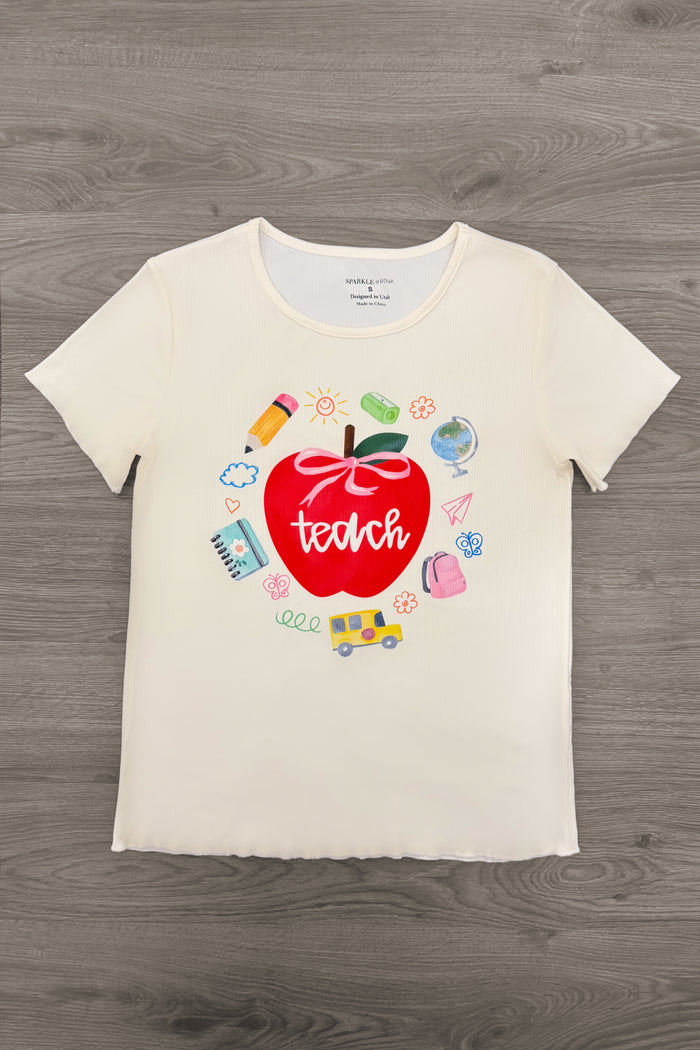 "Teach" Apple Top - MOM-XS - Cream short-sleeve top with red apple graphic and colorful school supplies surrounding "teach" text.