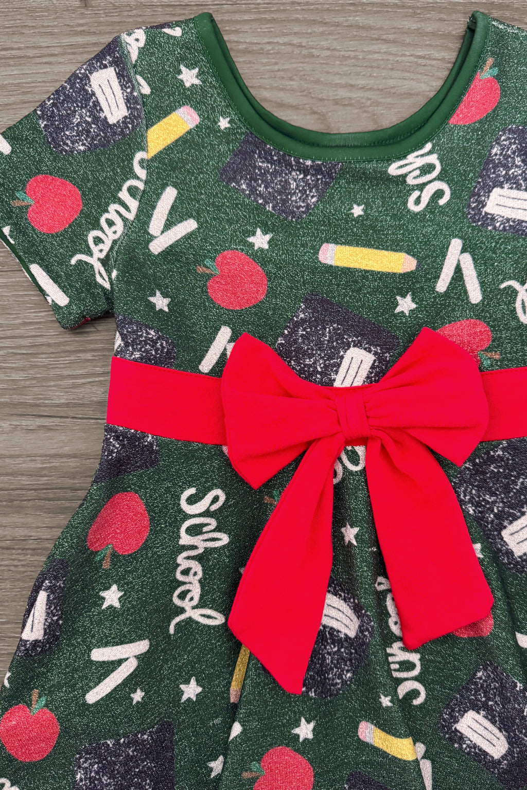 Green Glitter School Supplies Dress - 3T - Green glitter dress with school-themed prints and a red bow at the waist.