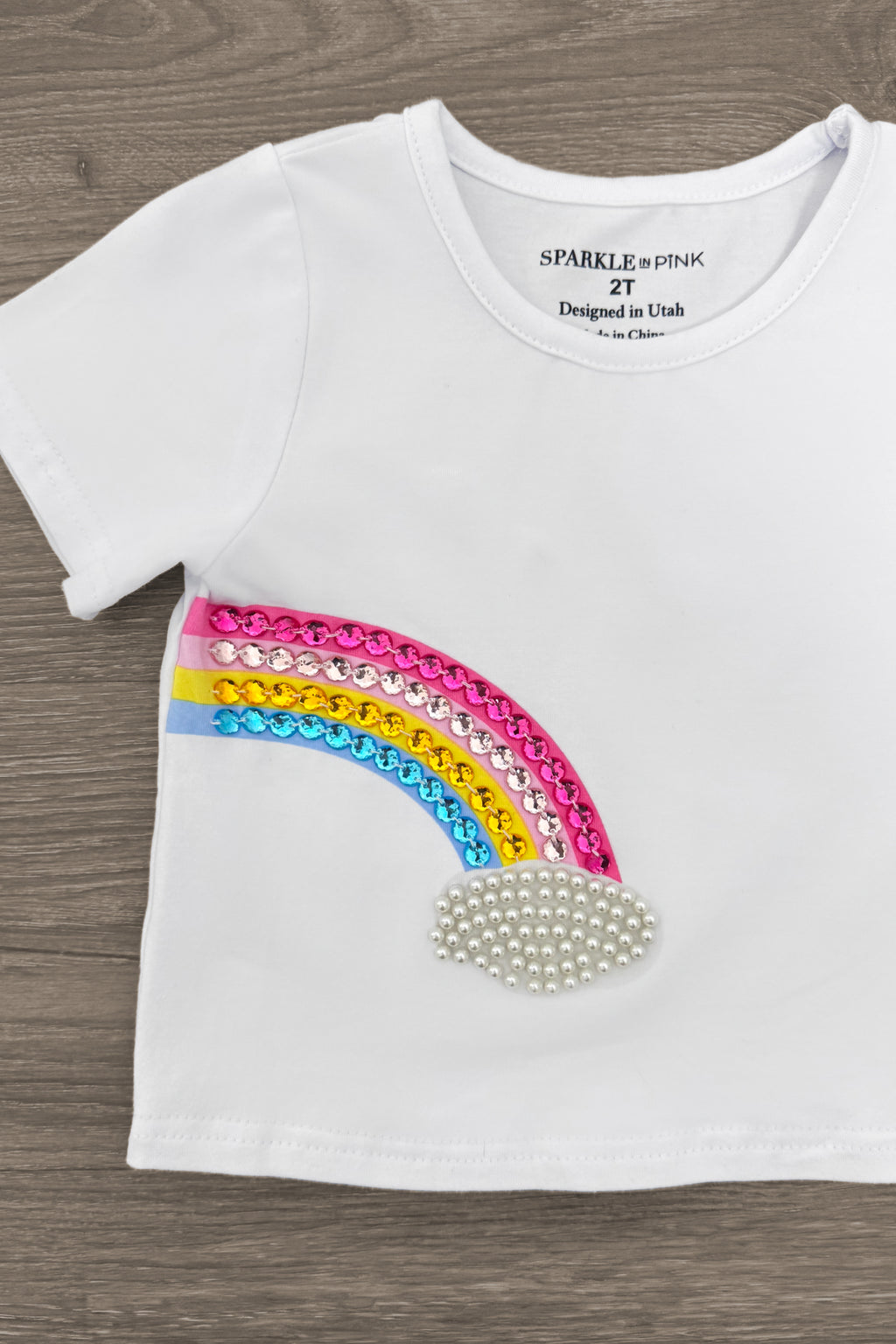 Gemstone Rainbow Denim Short Set - Left Side / 6-12 Months - White short-sleeve toddler t-shirt with colorful gemstone rainbow and pearl cloud embellishment on front.