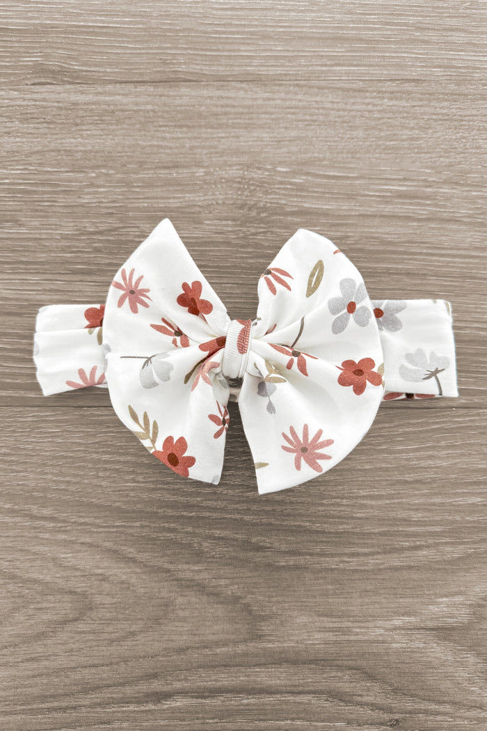 Bamboo Golden Petals Bow Headband - Default Title - Cream fabric bow headband with golden and rust floral print on wooden surface.