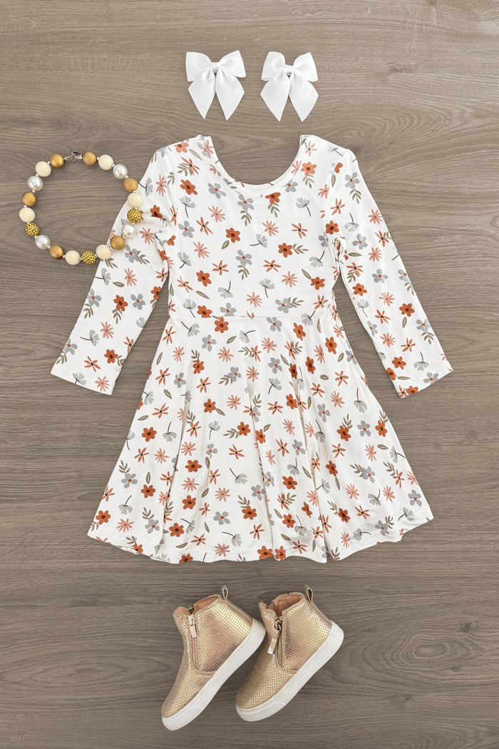 Bamboo Golden Petals Dress - 3XS-6-12 Months - Cream long-sleeve dress with golden and brown floral print, paired with white bows and beige boots.