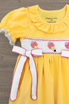 Yellow Pencil & Bows Dress - 3T - Yellow dress with puff sleeves, ruffled collar, white smocked panel featuring pink bows and ice cream motifs, white trim on.