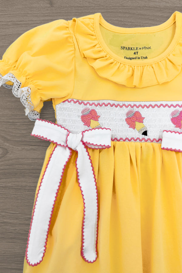 Yellow Pencil & Bows Dress - 3T - Yellow dress with puff sleeves, ruffled collar, white smocked panel featuring pink bows and ice cream motifs, white trim on.