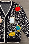 Mom & Me - Composition Sweater Cardigan - CHILD-3T - Black knit cardigan with white speckled pattern and colorful educational patches including apple, flower, notebook, globe,.