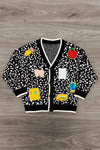 Mom & Me - Composition Sweater Cardigan - CHILD-3T - Black cardigan sweater with white speckles, colorful cartoon patches, and white trim on collar and cuffs.