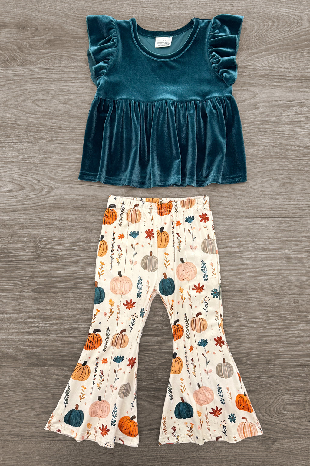 Velvet Pumpkin Flare Set - 6-12 Months - Turquoise velvet top with ruffled cap sleeves paired with cream bell-bottom pants featuring a colorful pumpkin print.