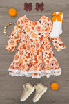 Autumn Pie Ruffle Dress - 6-12 Months - Orange long-sleeve dress with autumn-themed prints, ruffled sleeves, and white lace trim at hem.