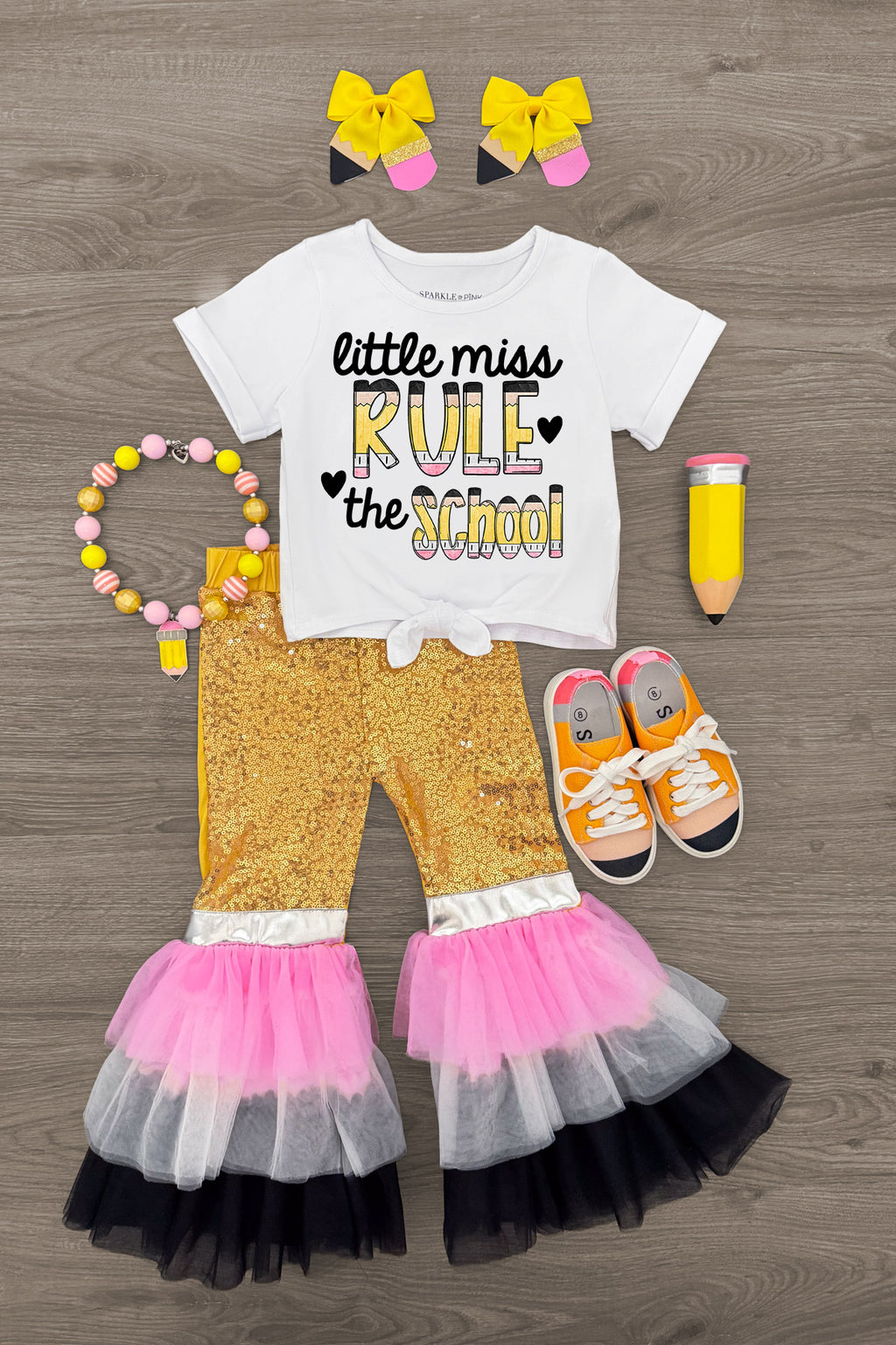 "Little Miss Rule The School" Bell Bottom Set - 3T - White short-sleeve top with "Little Miss Rule the School" text, yellow floral bell-bottom pants with pink, white, and black.