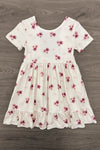 Pink Flowers & Bows Dress - 6-12 Months - White short-sleeve dress with pink and purple floral prints, gathered waist, and ruffled hem.