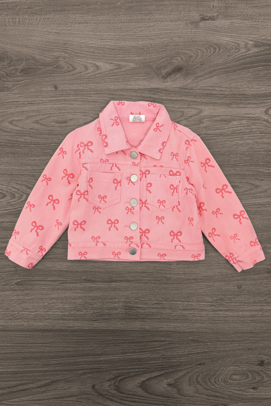 Pink Bow Denim Jacket - 6-12 Months - Pink denim jacket with all-over bow print, button front, collar, and long sleeves.