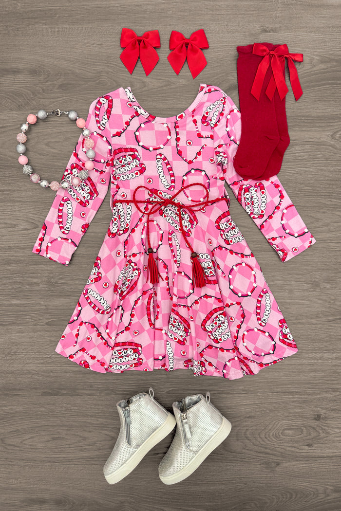 "In My Bestie Era" Pink Bamboo Bracelet Dress - 3XS-6-12 Months - Pink long-sleeve bamboo dress with red heart and chain print, red belt, matching red tights, red bow headbands, pearl and.