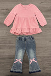 Pink Bow Denim Flare Pant Set - 6-12 Months - Pink long-sleeve top with ruffled hem and light blue denim flared pants featuring pink bow accents at the knees.