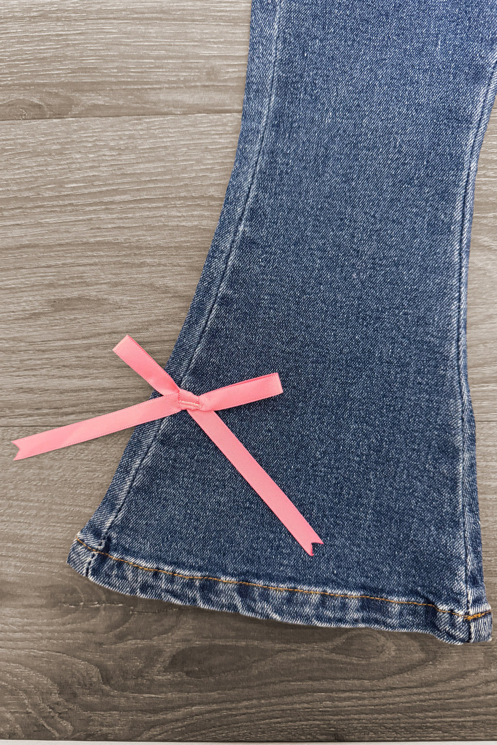 Pink Pony Denim Flare Pant Set - 6-12 Months - Blue denim flare pant leg with a pink ribbon bow detail near the hem.
