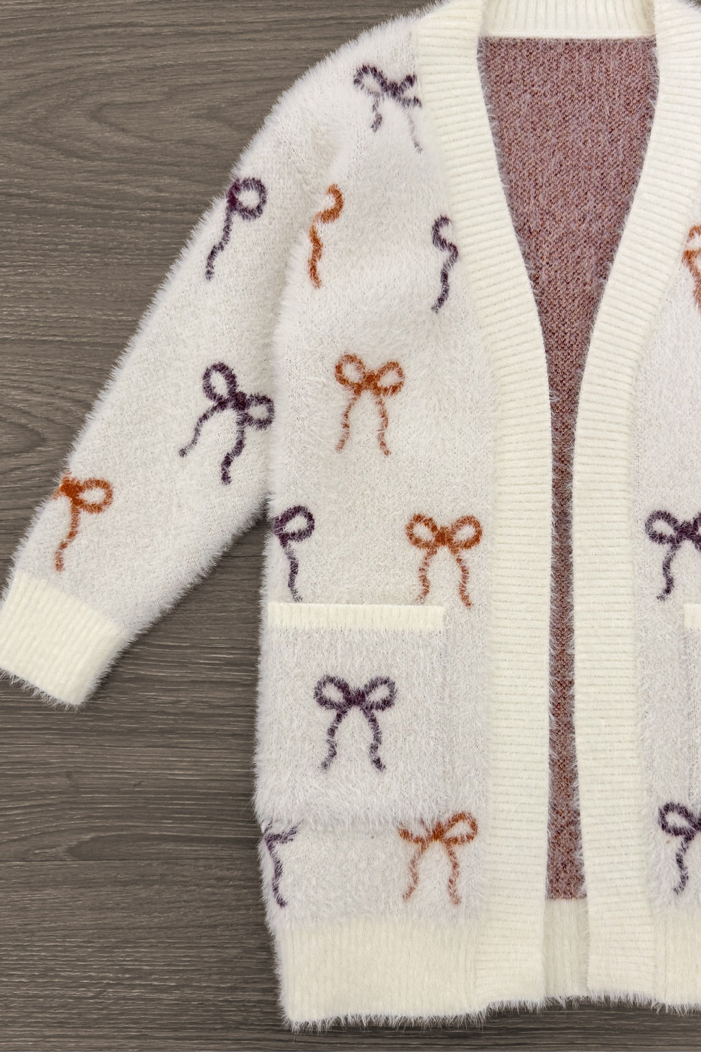 Mom & Me - Cozy Cream Bow Cardigan - CHILD-6-12 Months - Cream knit cardigan with burgundy and rust bow patterns and front patch pocket.