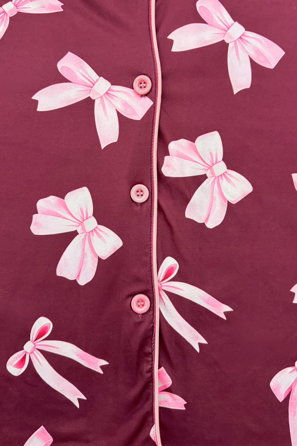 Mom & Me - Fuzzy Pink Bow Pajamas - CHILD-6-12 Months - Burgundy button-up pajamas with pink fuzzy bow prints and pink piping along the edges.