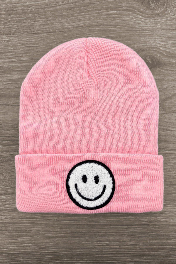 Smiley Face Beanies - Pink - Pink knitted beanie hat with folded cuff and black-and-white embroidered smiley face on front.