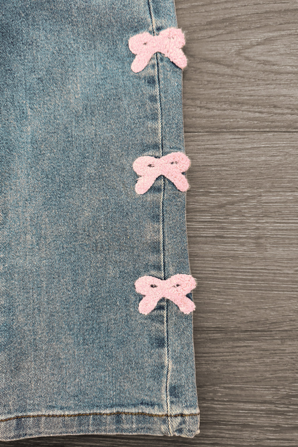 Pink Chenille Bow Denim Pants - 3-6 Months - Light blue denim pants featuring three soft pink chenille bows vertically aligned on the outer seam.