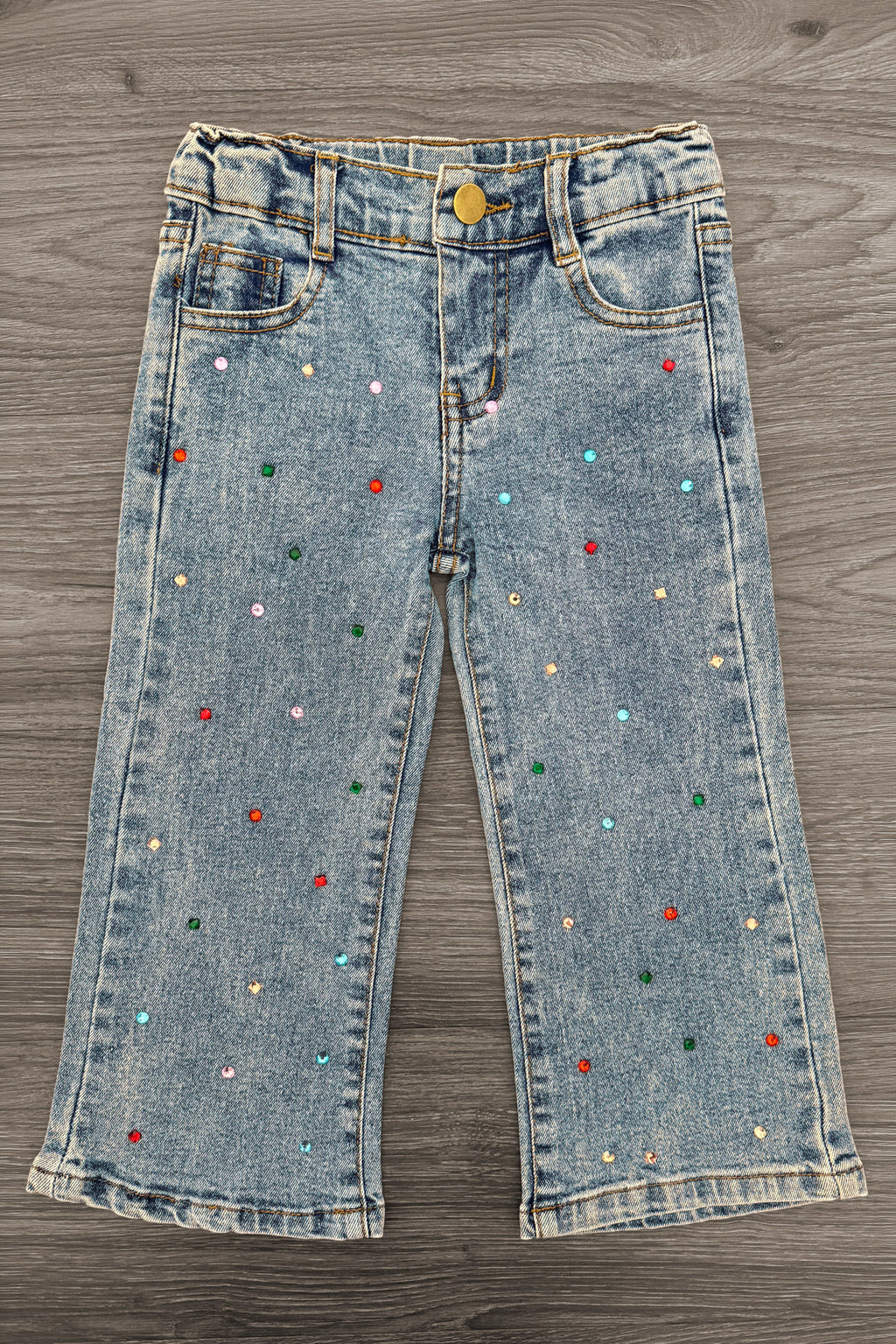 Gemstone Denim Pants - 6-12 Months - Light wash denim pants with colorful gemstone embellishments scattered across the fabric, featuring a button and zipper.