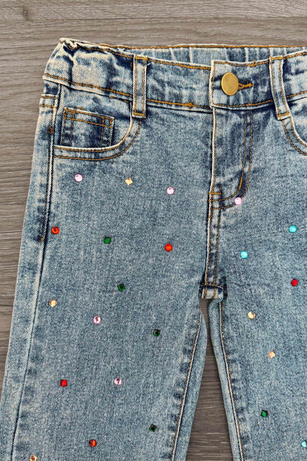 Gemstone Denim Pants - 6-12 Months - Light blue denim pants with scattered colorful gemstone embellishments and a brass button closure.