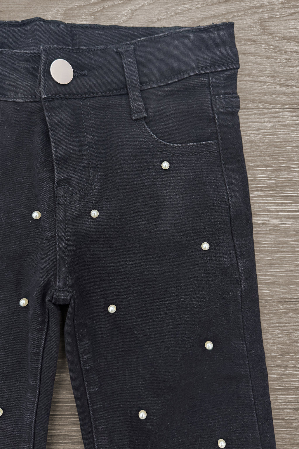 Striped Sweater Cardigan Denim Pant Set - 6-12 Months - Black denim pants with pearl embellishments and silver button closure on a wood surface.