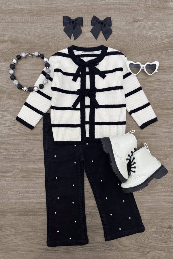 Striped Sweater Cardigan Denim Pant Set - 6-12 Months - Black and white striped knit cardigan with bow details, black wide-leg pants with pearl accents, white lace-up boots, black.