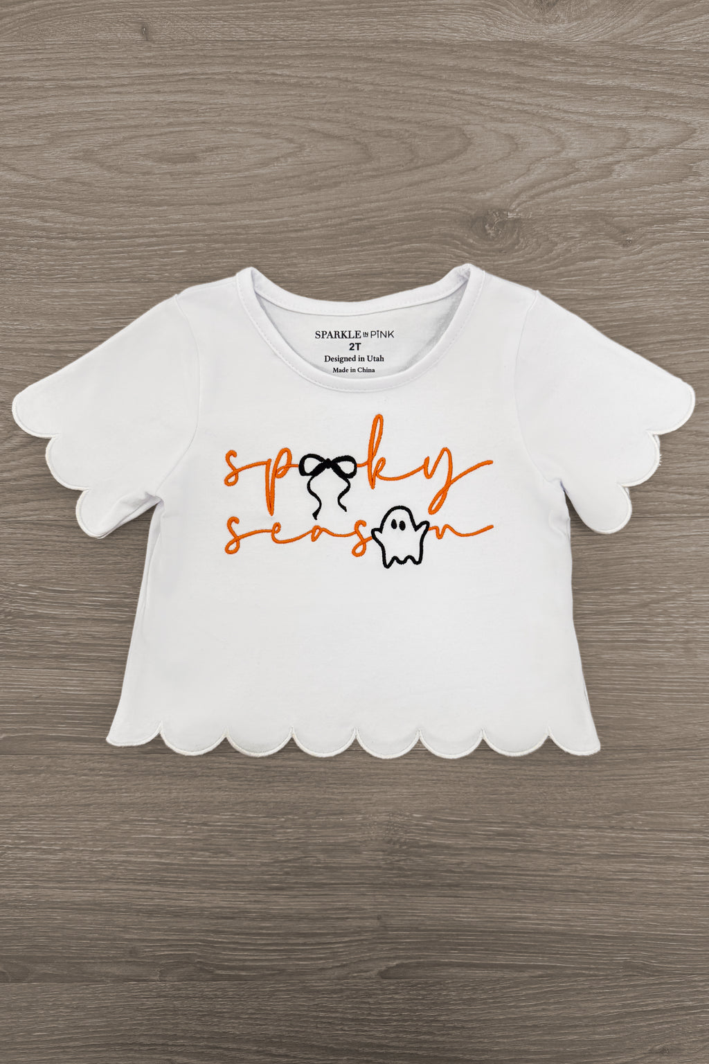 "Spooky Season" Bow Denim Pant Set - 6-12 Months - White short-sleeve crop top with scalloped edges and orange "spooky season" text with a small ghost graphic.