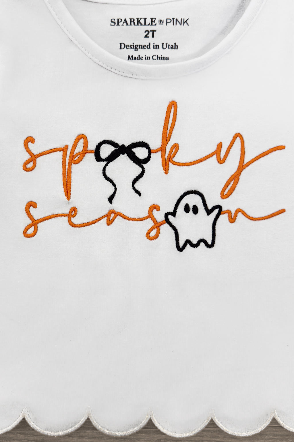 "Spooky Season" Bow Denim Pant Set - 6-12 Months - White toddler long-sleeve top with scalloped hem and orange "spooky season" text featuring a black bow and ghost graphic.