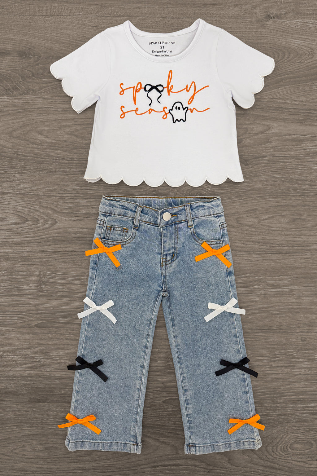 "Spooky Season" Bow Denim Pant Set - 6-12 Months - White short-sleeve scalloped hem top with orange "spooky season" text paired with light blue denim pants featuring orange,.