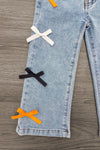 "Spooky Season" Bow Denim Pant Set - 6-12 Months - Light blue denim pants with white, black, and orange bows vertically aligned on the pant leg.