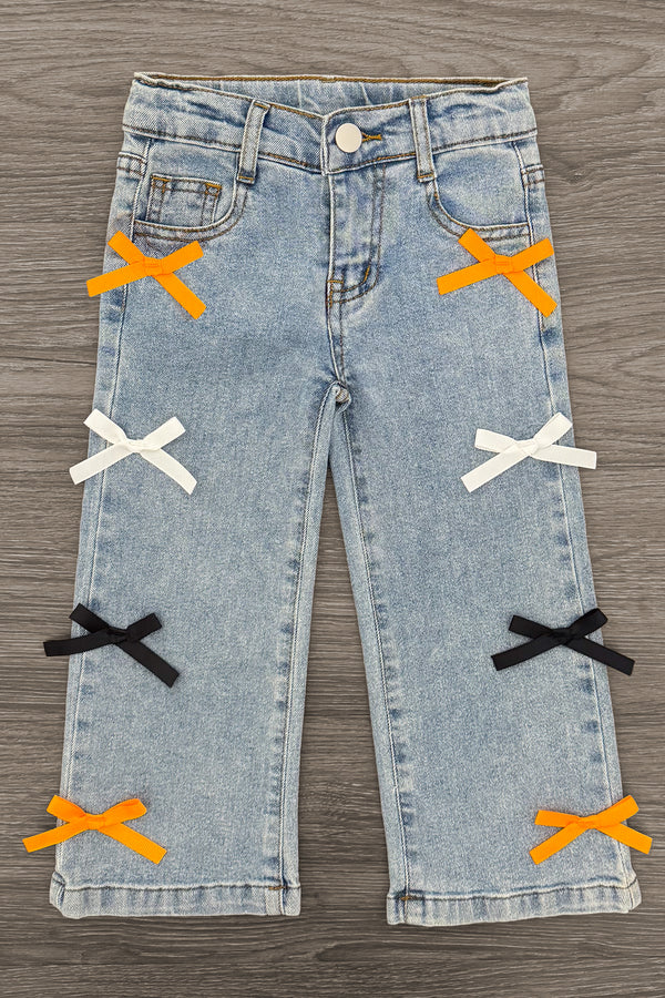 "Spooky Season" Bow Denim Pant Set - 6-12 Months - Light blue denim pants with decorative orange, white, and black bow accents on front legs.