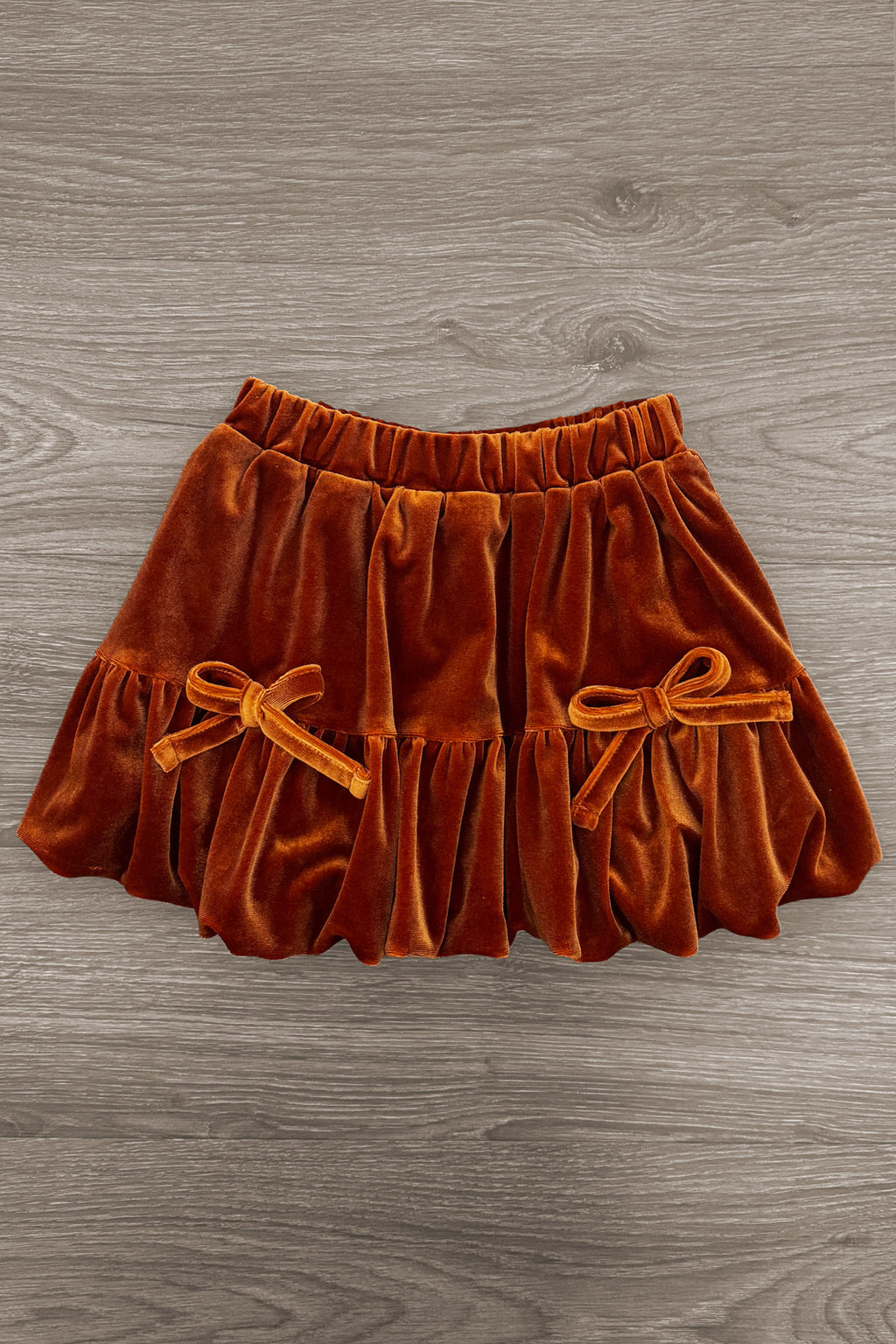 "Fall" Rust Floral Suede Skirt Set - 6-12 Months - Rust-orange suede skirt with elastic waistband and two small decorative bows on front pleated panels.