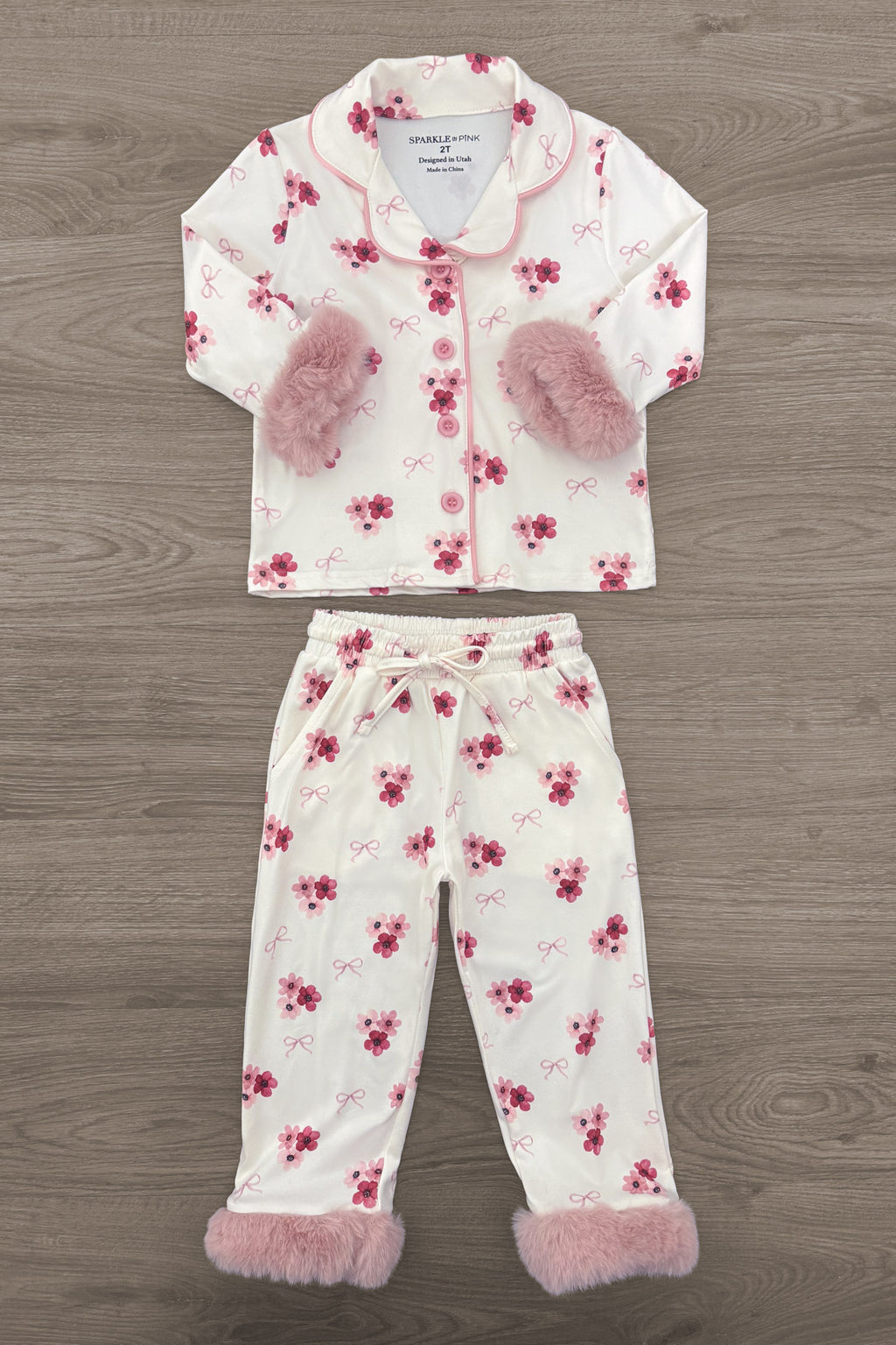 Mom & Me - Fuzzy Flower & Bow Pajamas - CHILD-6-12 Months - Cream and pink fuzzy fleece pajamas with floral print, featuring bow accents on the sleeves and cuffs.