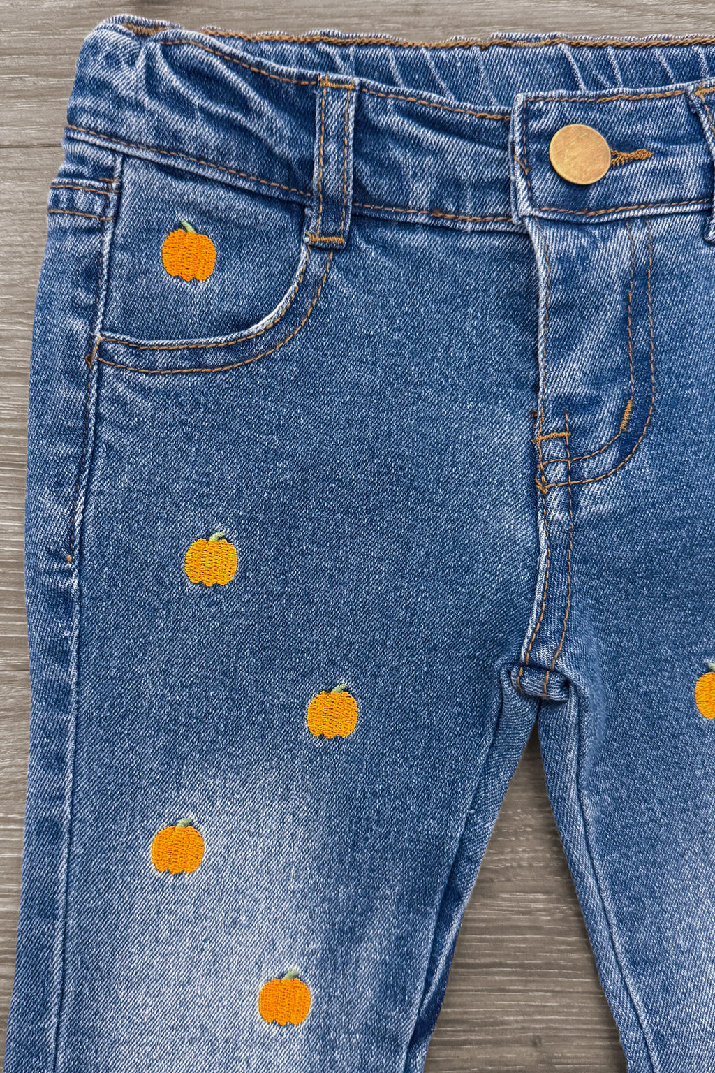 Pumpkin Denim Flare Set - 6-12 Months - Blue denim flare pants with embroidered small orange pumpkins scattered on front.
