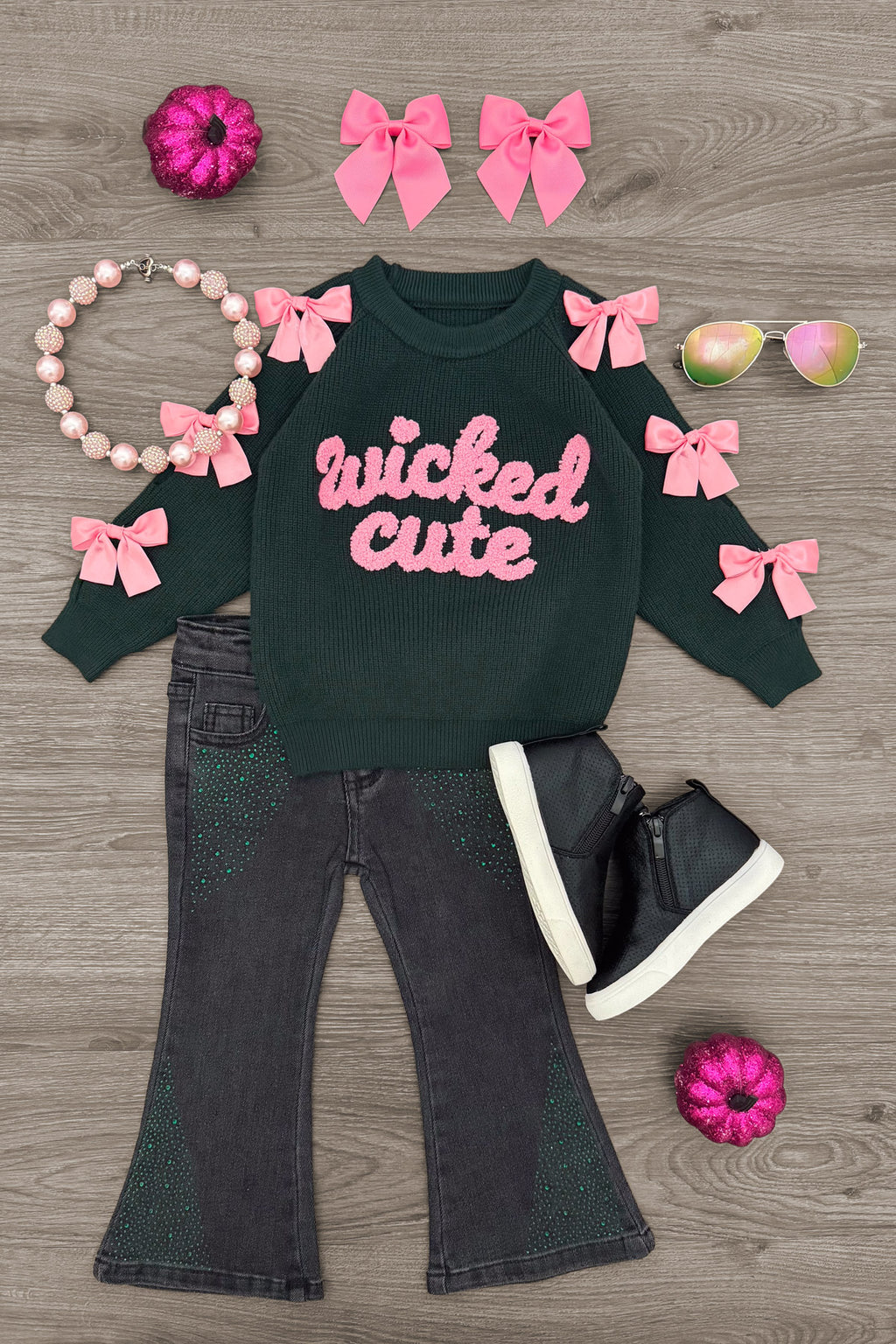 "Wicked Cute" Denim Flare Set - 6-12 Months - Black denim flare jeans with green "wicked cute" sweatshirt featuring pink bows and black high-top sneakers.
