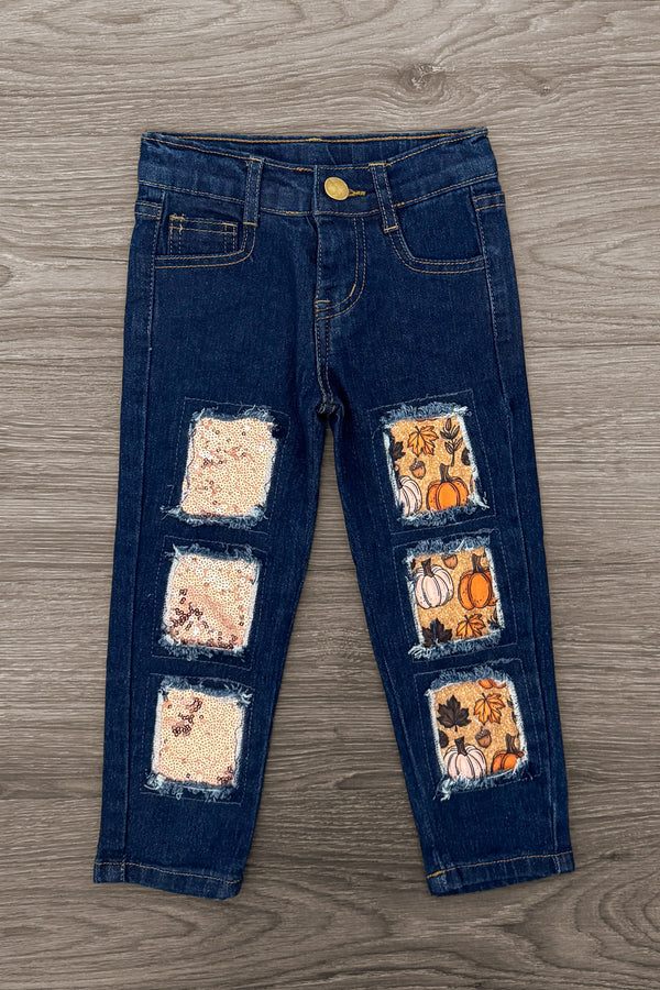 Pumpkin Denim Pant Set - 6-12 Months - Dark blue denim pants with stitched-on orange and cream pumpkin and floral fabric patches on the front legs.