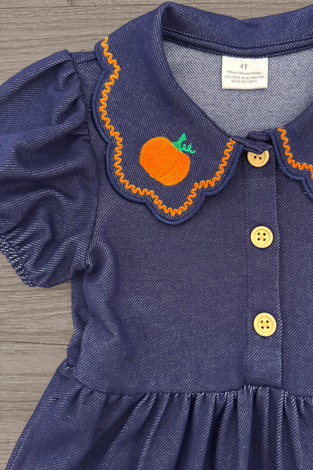 Faux Denim Pumpkin Dress - 6-12 Months - Blue faux denim dress with puff sleeves, scalloped collar embroidered with an orange pumpkin, and yellow buttons down the.