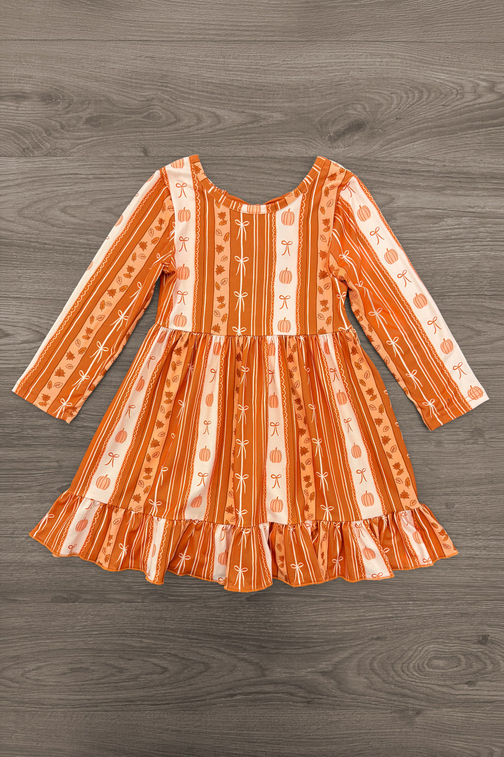 Pumpkins & Bows Stripe Dress - 6-12 Months - Orange long-sleeve girl’s dress with vertical floral and stripe patterns and a ruffled hem.