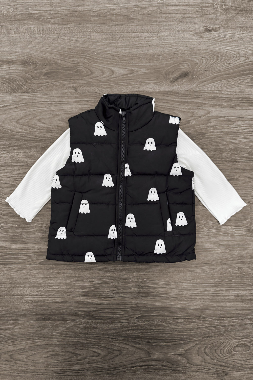 Mom & Me - Ghost Vest Set - CHILD-6-12 Months - Black padded vest with white ghost prints layered over long-sleeve white shirt on wood floor background.