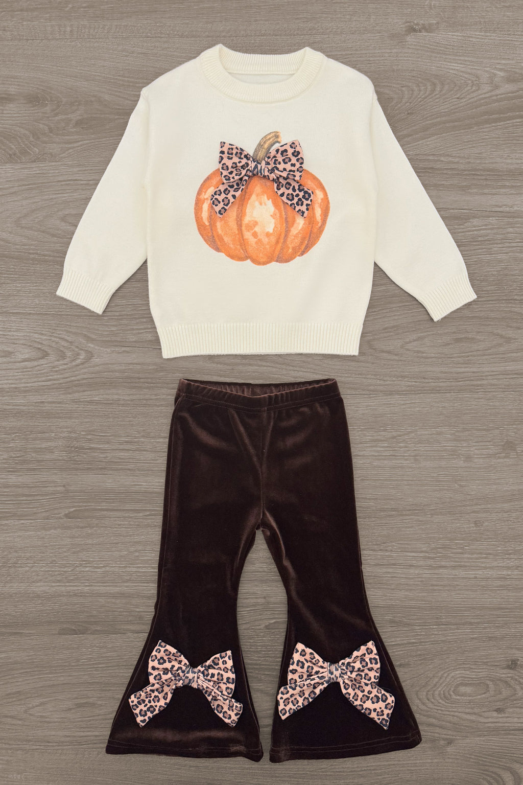 Cheetah Pumpkin Velvet Flare Set - 6-12 Months - Cream long-sleeve top with pumpkin and cheetah bow graphic paired with brown velvet flare pants featuring cheetah print bows