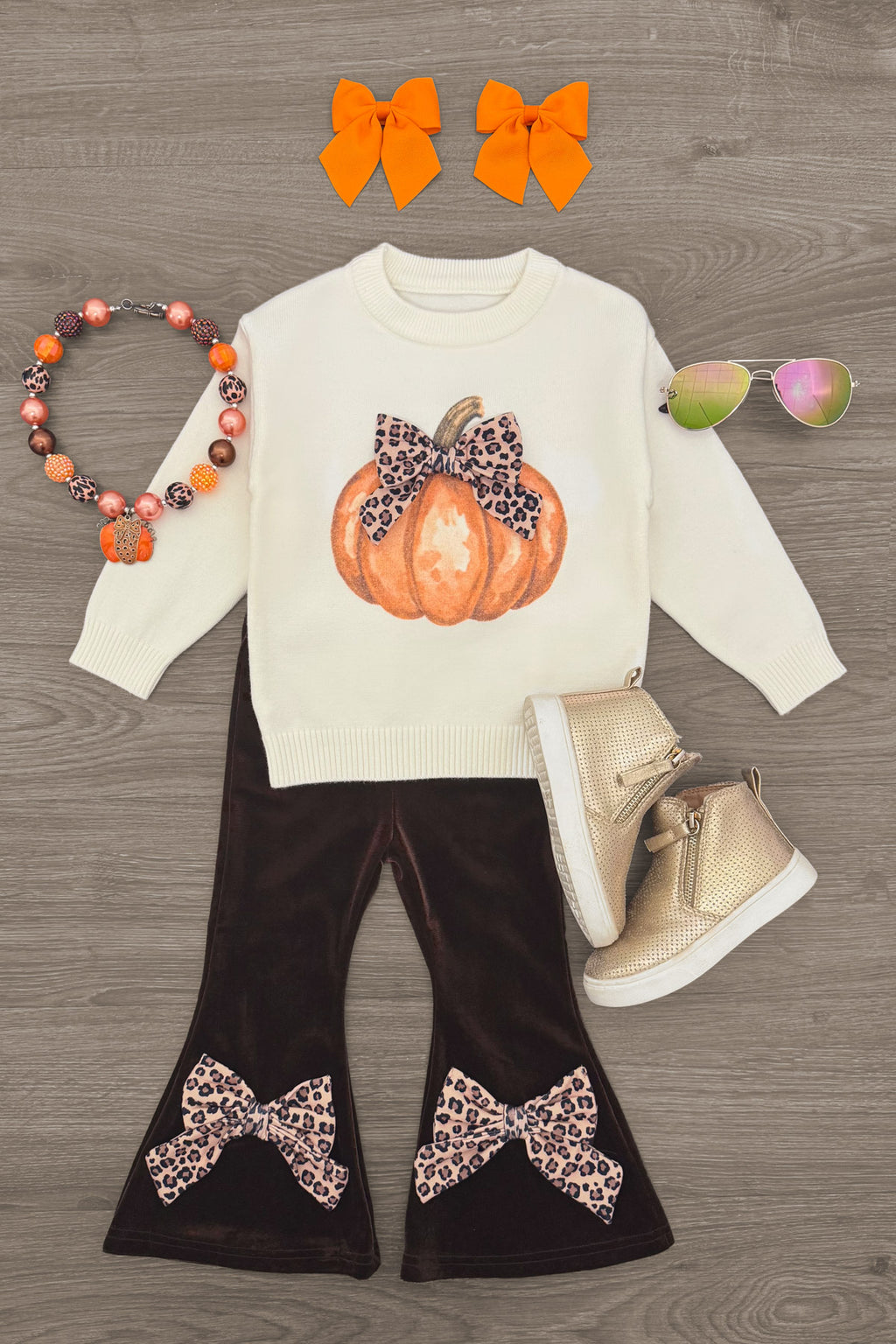 Cheetah Pumpkin Velvet Flare Set - 6-12 Months - Cream long-sleeve top with cheetah print pumpkin graphic, dark brown velvet flare pants with cheetah bows at hems, paired.