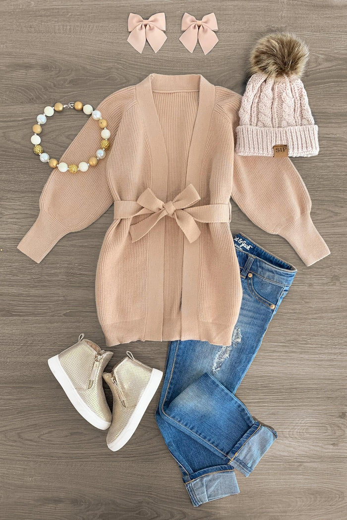 Tan Cardigan Sweater - 3XS-6-12 Months - Tan knit cardigan with waist tie paired with blue rolled cuff jeans, beige glitter sneakers, pom-pom beanie, bow hair clips, .